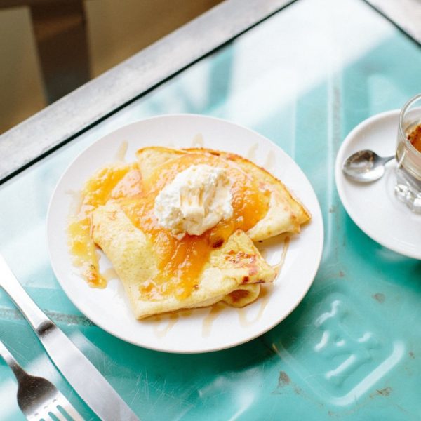 swedish pancakes with peach jam, maple syrup, and mascarpone whipped cream from Blueprint Coffee.