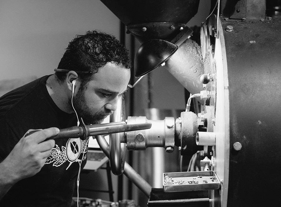 Mazi Razani evaluates coffee by aroma while roasting at Blueprint Coffee.