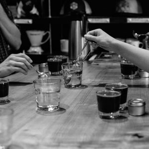 Tasters rinse their spoons between each coffee at a cupping.