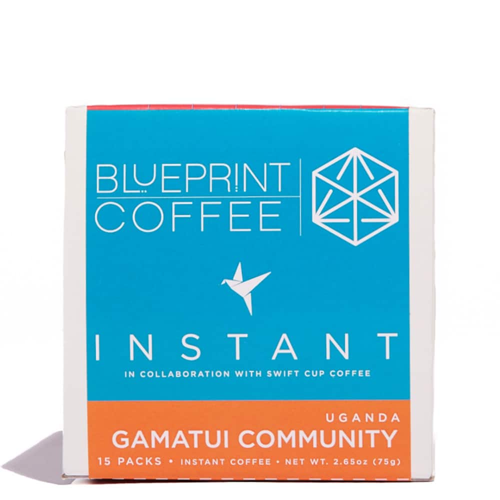 A 15-pack box of Blueprint Coffee's Gamatui Community instant coffee. It features the Blueprint Logo in blue along with the swift cup logo. The name gamatui community is written across the bottom atop an orange backdrop.