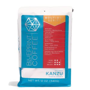 A 12-ounce bag of Kanzu, Rwanda coffee beans. It features the Blueprint Coffee logo in blue on the left side with coffee details on the right in red.