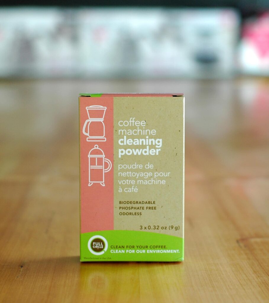 Box of home cleaning powder on a wooden table.