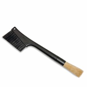 The black Pallo Grindminder brush with stiff black bristles on the left side and soft, brown fine cleaning bristles on the right.