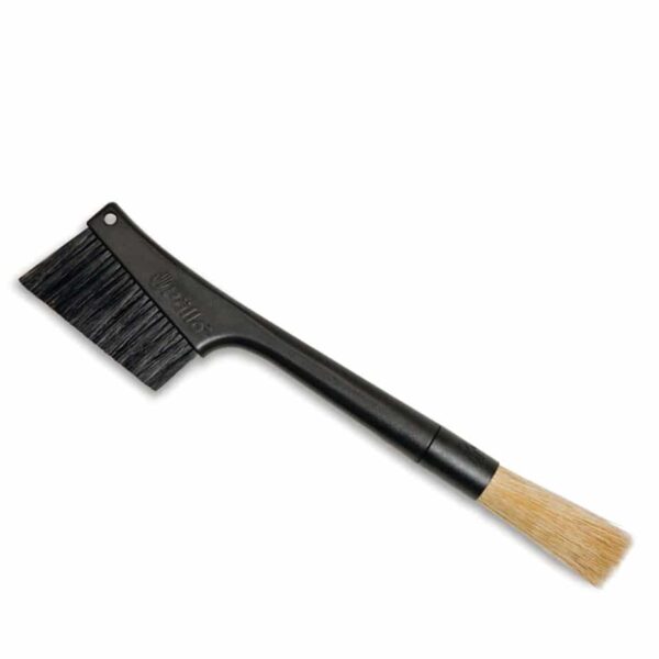 The black Pallo Grindminder brush with stiff black bristles on the left side and soft, brown fine cleaning bristles on the right.
