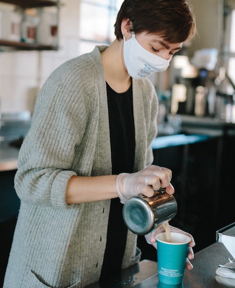 MG 3 MG Batts pours coffee into a Blueprint Coffee to go cup