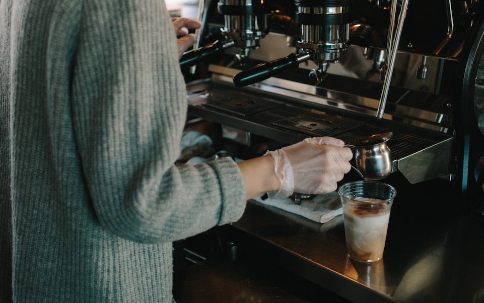 MG 4 MG makes an iced dirty chai in front of the espresso machine