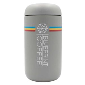 A 12-ounce grey insulated coffee tumbler with the blueprint branding.