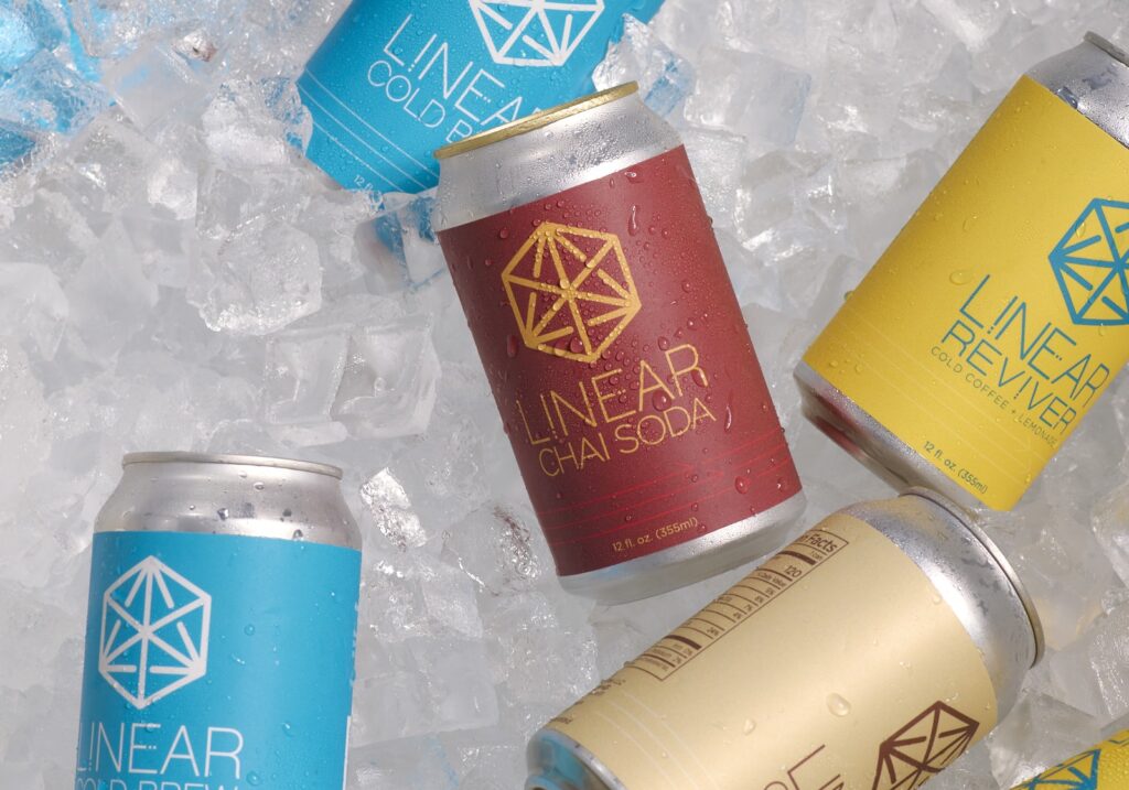 cans of linear craft beverages in a cooler filled with ice