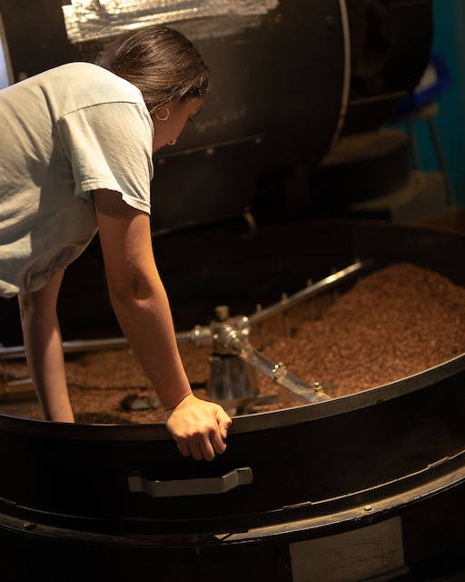 Marija reaches into the cooling tray of the roaster