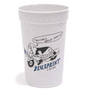 A grey plastic cup with an illustration of someone reading a motorcycle above text that reads "Blueprint Coffee."