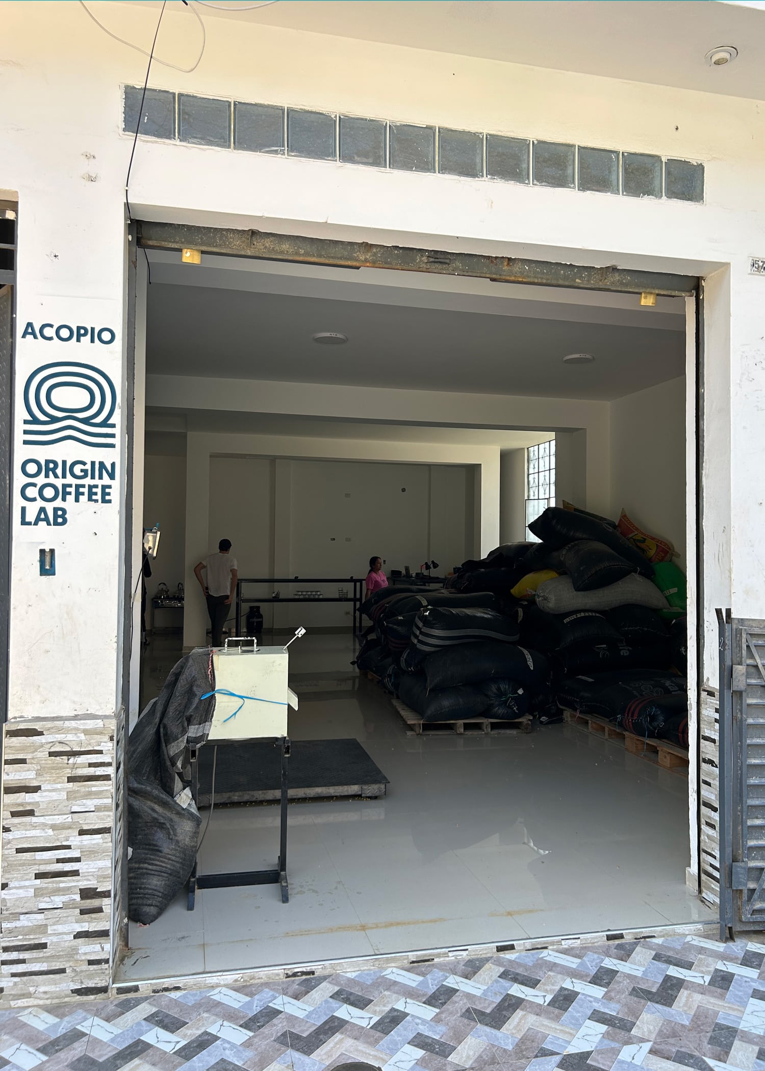 The arrival door for the OCL lab where farmers will drop off coffee they'd like to sell. The OCL purchasing point where farmer drop off coffee for analysis and potential sale.