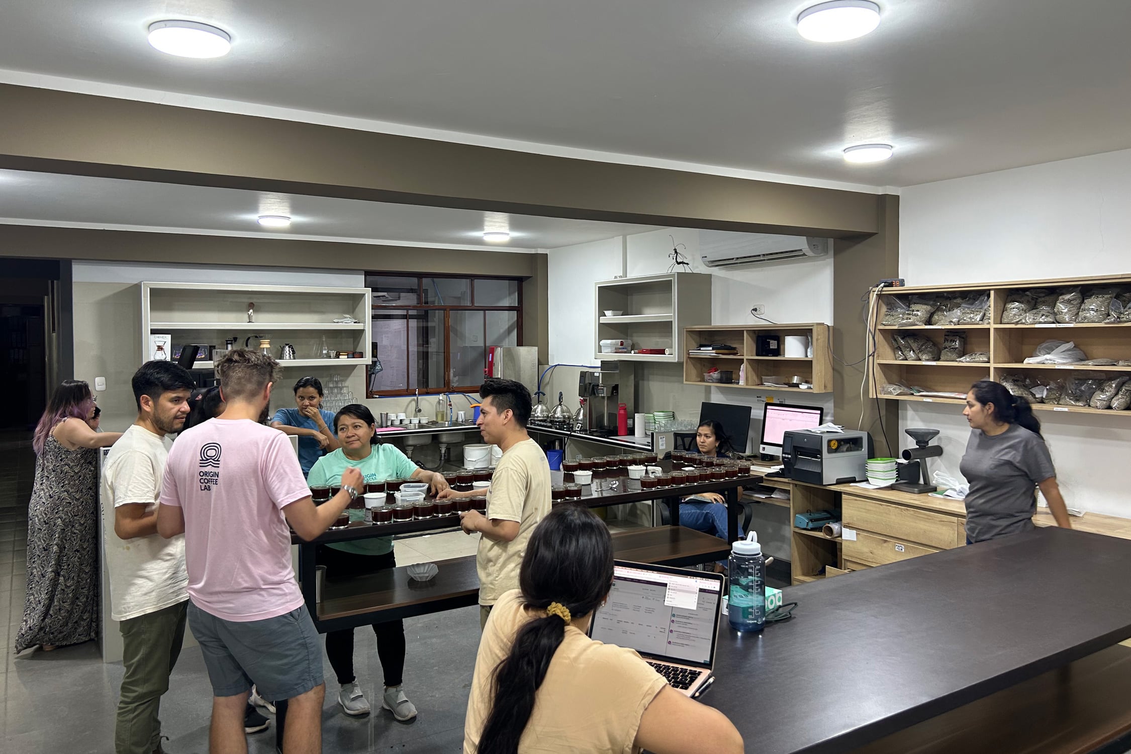 The cupping lab at OCL in action. Nora Brady through windows