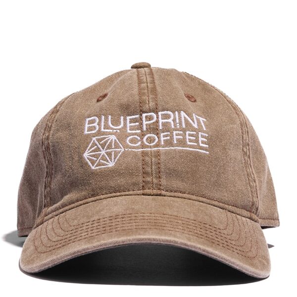 The front of the brown Blueprint Dad hat which features an embroidered white Blueprint Coffee logo.