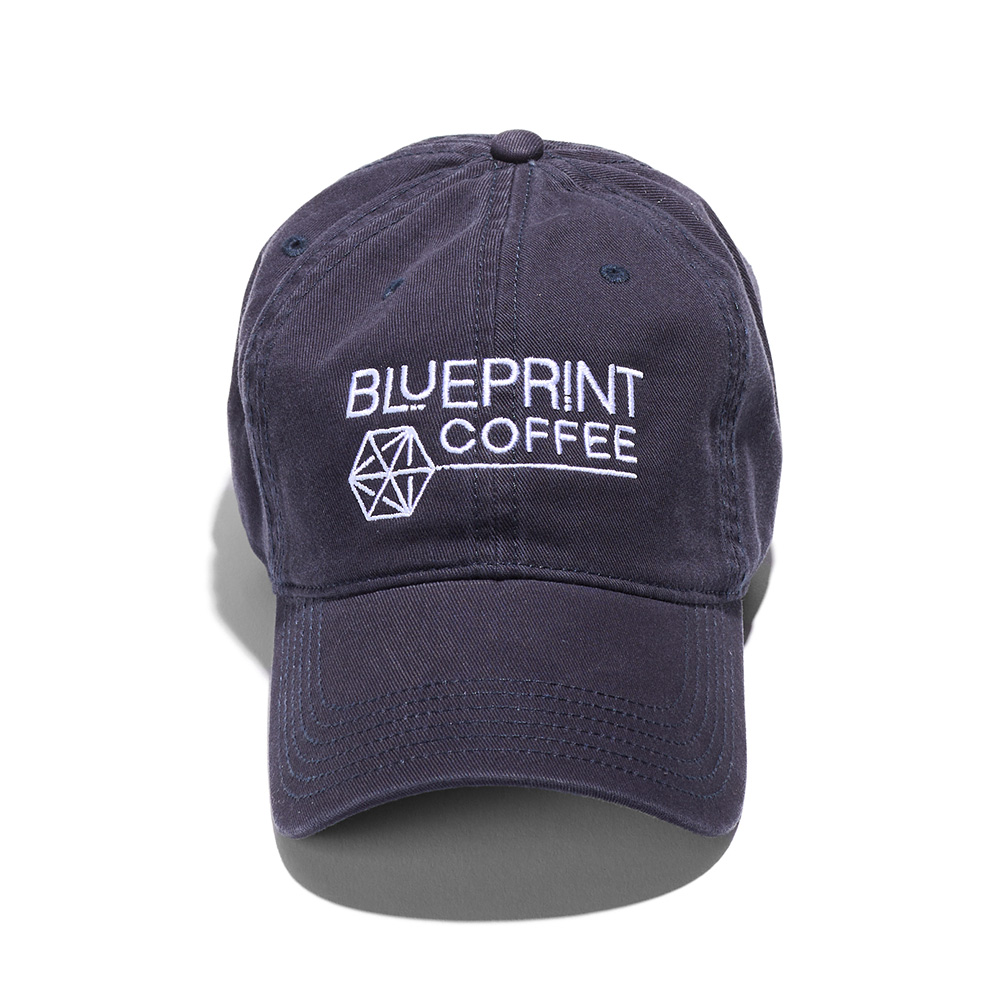 A dark navy blue dad hat embroidered with the Blueprint Coffee logo in white thread across the front