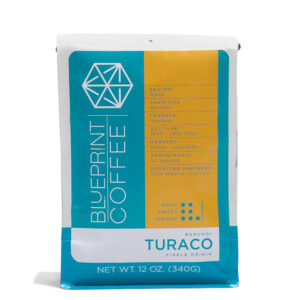 A 12-ounce bag of Turaco, Burundi coffee beans. It features the Blueprint Coffee logo in blue on the left half and product information in yellow on the right half.