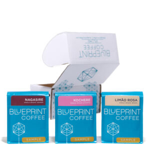 Three sample bags of Blueprint Coffee in front of a cardboard sampler box decorated with the Blueprint Coffee logo.