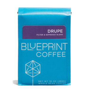 A blue 10-ounce bag of Drupe Filter & Espresso Blend coffee beans featuring the Blueprint Coffee Logo and a removable info card.