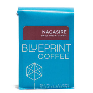 A blue 10-ounce bag of Nagasire, Uganda coffee beans featuring the Blueprint Coffee Logo and a removable info card.