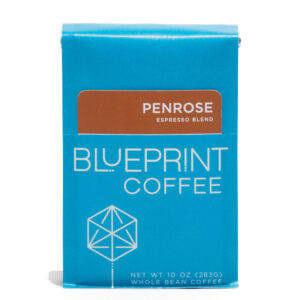 A blue 10-ounce bag of Penrose Espresso coffee beans featuring the Blueprint Coffee Logo and a removable info card.