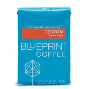 A blue 10-ounce bag of Tektōn filter blend coffee beans featuring the Blueprint Coffee Logo and a removable info card.