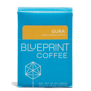 A blue 10-ounce bag of Gura, Kenya coffee beans featuring the Blueprint Coffee Logo and a removable info card.