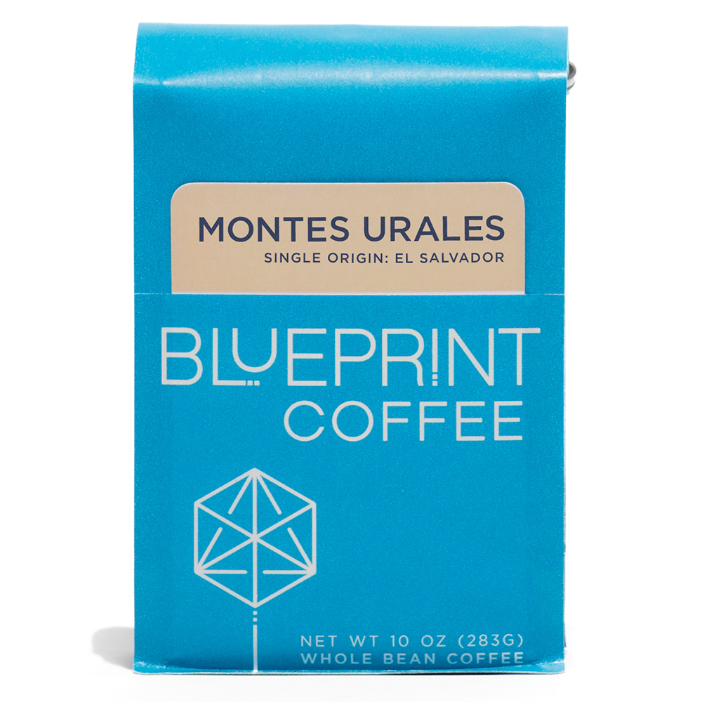 A 10-ounce bag of Montes Urales, El Salvador coffee beans. The photo shows a blue package bearing the Blueprint Coffee name and logo along with the coffee's name in cream and blue.
