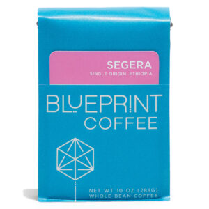 A blue 10-ounce bag of Segera, Ethiopia coffee beans featuring the Blueprint Coffee Logo and a pink removable info card.