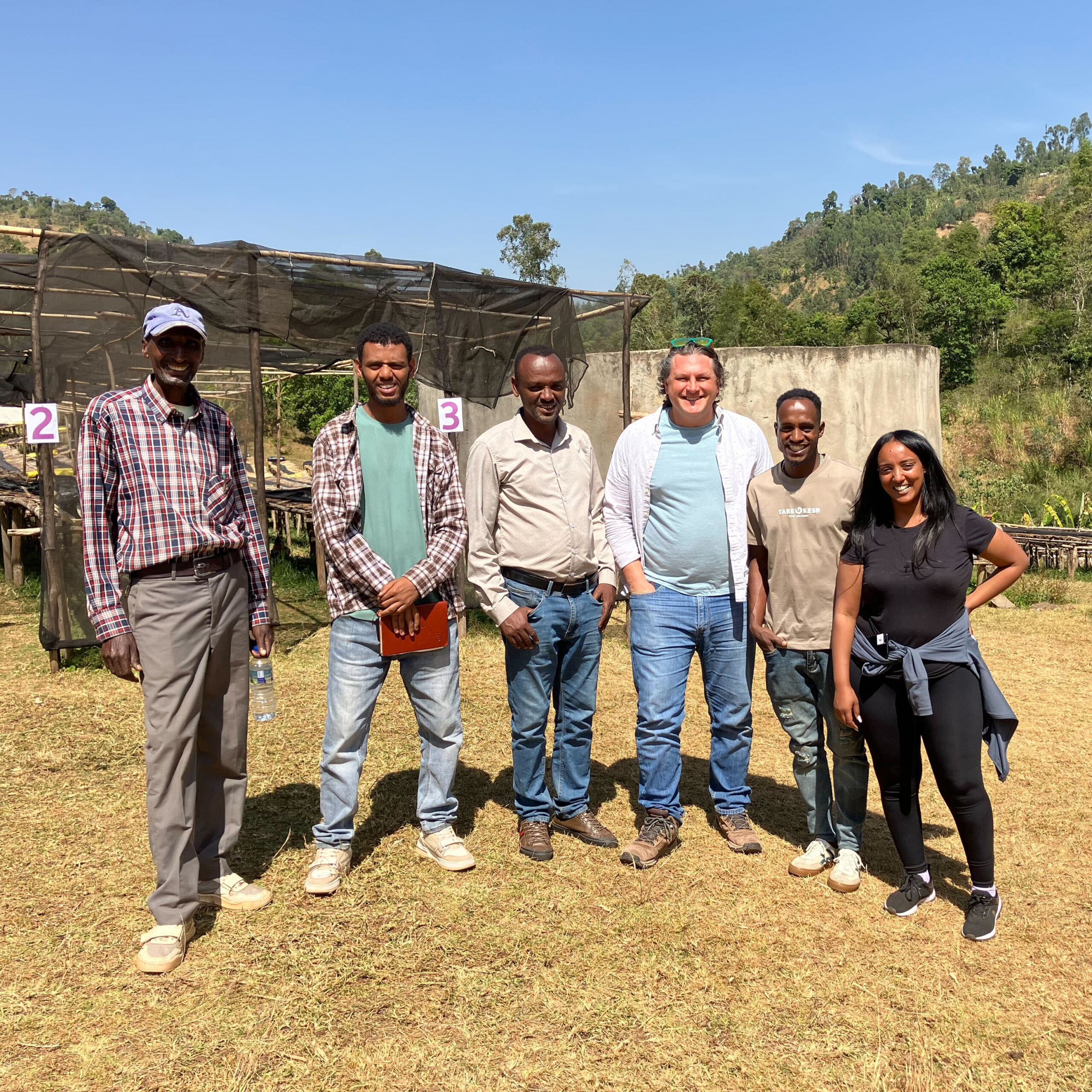Blueprint member Mike stands with station workers at the Bensa Segera station in Ethiopia.
