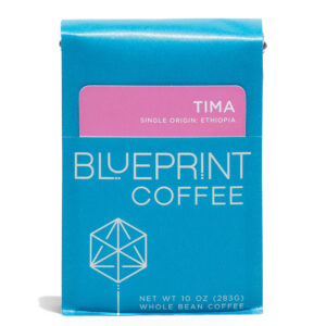 A blue 10-ounce bag of Tima, Ethiopia coffee beans featuring the Blueprint Coffee Logo and a pink removable info card.