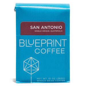 A blue 10-ounce bag of San Antonio, Guatemala coffee beans featuring the Blueprint Coffee Logo and a maroon red removable info card.